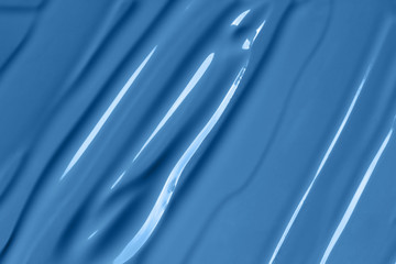 Classic blue makeup background. Liquid cream or paint strokes texture