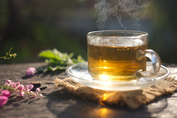Tea cup on the wooden table and the morning light background