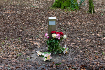 Woodland shrine grave memorial with flowers