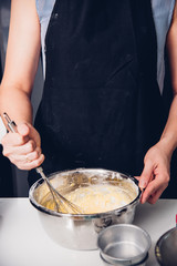 Woman beat dough mixer manual by hands