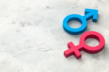 Gender symbols of man and woman on a gray background