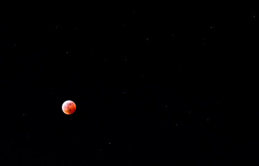 Moon eclipse, an airplane flying throw the sky while