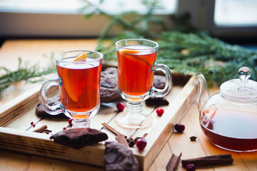 cup of fruit tea , winter still life on the window, chocolate cookies , fir tree 