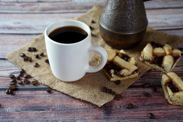 A Cup of coffee, pieces of homemade cake and Turkish coffee pot on the table