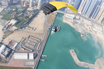 Outdoors. Fly men is a pilot of his body in air. Extreme people prefer skydiving. Parachutist in white suit. Free lifestyle.