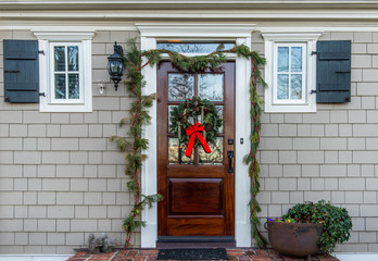 The front door to a house decorated with a holiday wreath