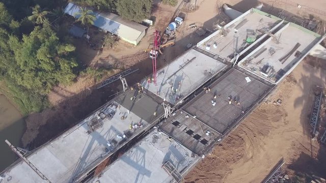 aerial static view of the pump truck that sent a mixture of cement, sand, gravel and water through a long of aerial pipe to reach the foundation of the new bridge