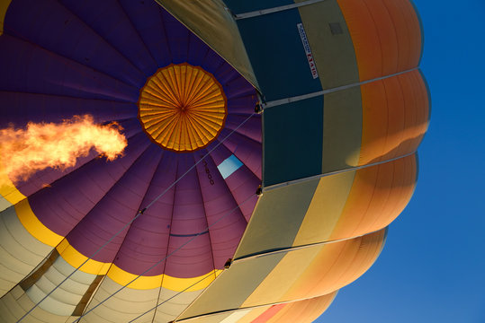 View from basket up to flame from propane heater inflating hot air balloon in Cappadocia Turkey