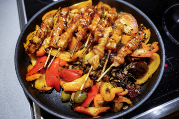 Stockholm, Sweden A home-made stir-fry with chicken skewers, peppers, olives, eggplant, onion and garlic and nuts.