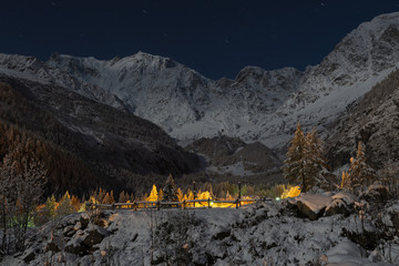 Winter mountain landscape illuminated by the full moon.  Macugnaga (Staffa - Pecetto), northern Italy. Important ski resort in the European Alps with Monte Rosa (4634 m) at night