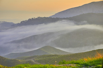 Beautiful Sunrise over Clouds and Mountains