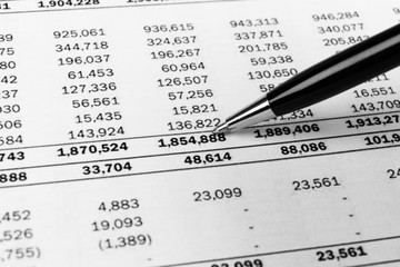 Obraz premium Financial concept. Calculator, pen and glasses on financial documents. Financial accounting. Balance sheets. Closeup of financial statements and annual reports. Business marketing