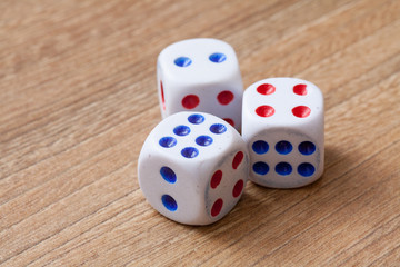 three dice on wooden desk background