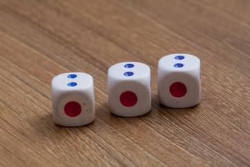 three dice on wooden desk background