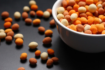 Peanuts with a crispy crust around is snack food often used at parties.