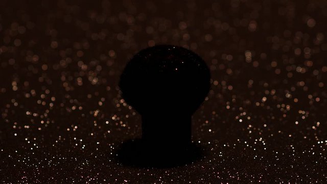 Lush makeup brush and gold sequins. A woman's hand touches the pile and makes a cloud of sequins