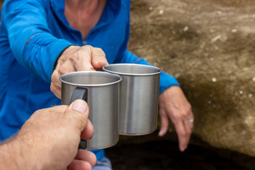 Fototapeta na wymiar man and woman holding stainless steel mugs