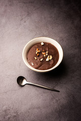 Sweet Ragi Malt / Healthy Ragi Porridge in a bowl garnished with crushed dry fruits