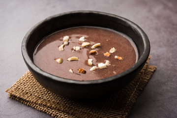 Sweet Ragi Malt / Healthy Ragi Porridge in a bowl garnished with crushed dry fruits