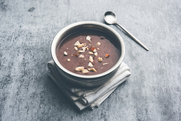 Sweet Ragi Malt / Healthy Ragi Porridge in a bowl garnished with crushed dry fruits