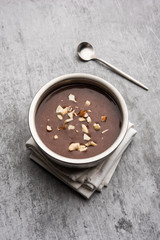 Sweet Ragi Malt / Healthy Ragi Porridge in a bowl garnished with crushed dry fruits