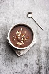 Sweet Ragi Malt / Healthy Ragi Porridge in a bowl garnished with crushed dry fruits