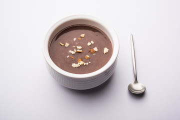 Sweet Ragi Malt / Healthy Ragi Porridge in a bowl garnished with crushed dry fruits