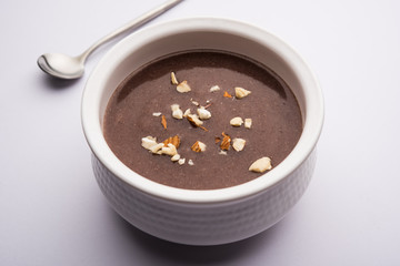 Sweet Ragi Malt / Healthy Ragi Porridge in a bowl garnished with crushed dry fruits
