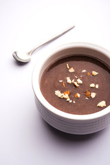Sweet Ragi Malt / Healthy Ragi Porridge in a bowl garnished with crushed dry fruits