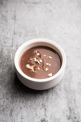Sweet Ragi Malt / Healthy Ragi Porridge in a bowl garnished with crushed dry fruits