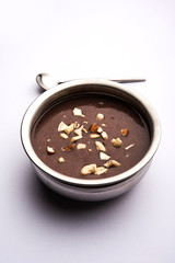 Sweet Ragi Malt / Healthy Ragi Porridge in a bowl garnished with crushed dry fruits