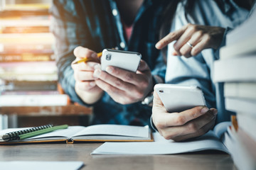 contact Asian businessman professional people thinking while working writing information documents in home offices at desk with computer,laptop,cell phone,business report chart