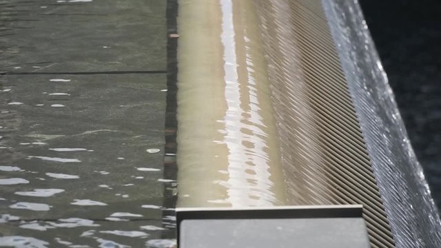 This was taken at a higher frame rate and has been converted to a slow motion video clip. World Trade Center structure, close up of the water falling.