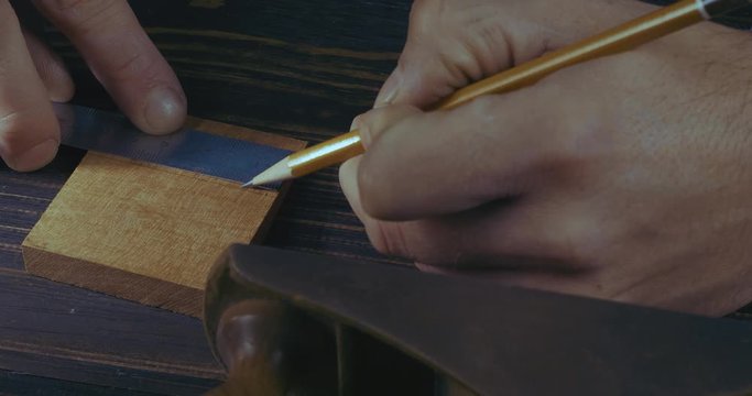 Close-Up Of Man&rsquo;s Hands Marking A Wooden Detail With A Pencil And A Ruler For Making A Wooden Comb. Handmade Craftsman Makes A Wooden Beard Comb. Cinema 4K Video