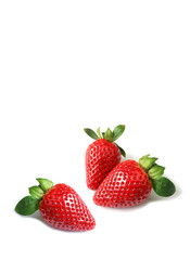 Vibrant red fresh strawberries scattered on white background with copy space