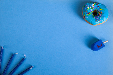 colorful doughnut dreidel candles blue background studio