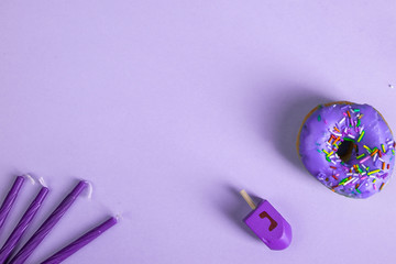 colorful doughnut dreidel candles purple background studio