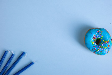 colorful doughnut candels blue background studio