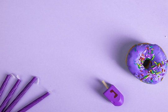 colorful doughnut dreidel candles purple background studio