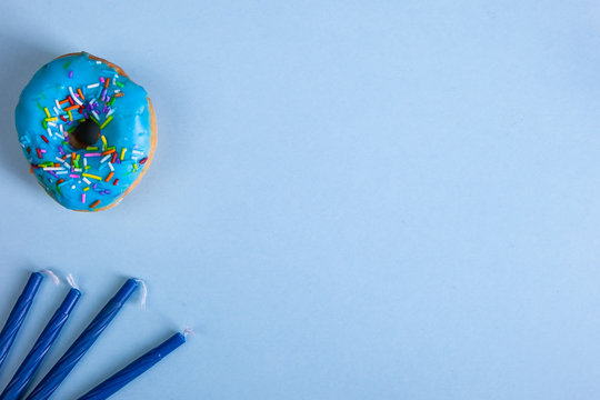colorful doughnut dreidel candels blue background studio