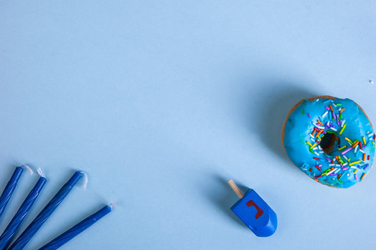 colorful doughnut dreidel candels blue background studio