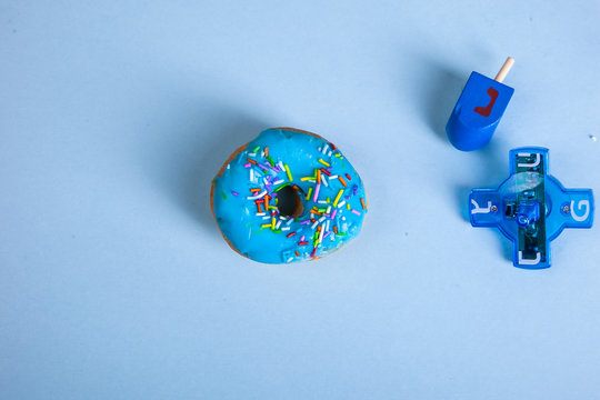 colorful doughnut dreidel blue background studio