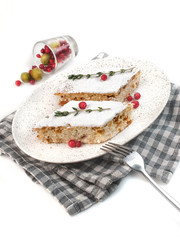 homemade cake slices covered with icing sugar with berries on a white background isolated