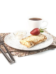 pancake stuffed with cottage cheese with strawberries on a white background isolated