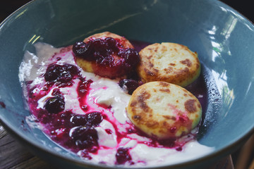  Close up oroginal russian food style greek cheese pancakes with yogurt and fruit jam