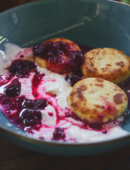  Close up oroginal russian food style greek cheese pancakes with yogurt and fruit jam