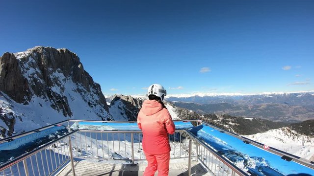 Active holiday winter alps. Girl taking pictures on cell phone of panorama in Austrian Alps. Stabilized footage.