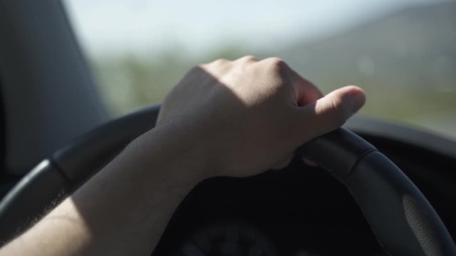 This is a clip of a hand on a car wheel driving. Cinematic, I think so.