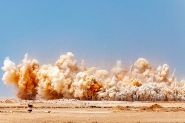 Dust clouds after detonator blast in the desert 