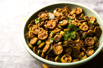 Fototapeta premium Tendli / Kundroo sabzi or Kovakkai Poriyal also known as ivy gourd, served in a bowl or karahi. selective focus